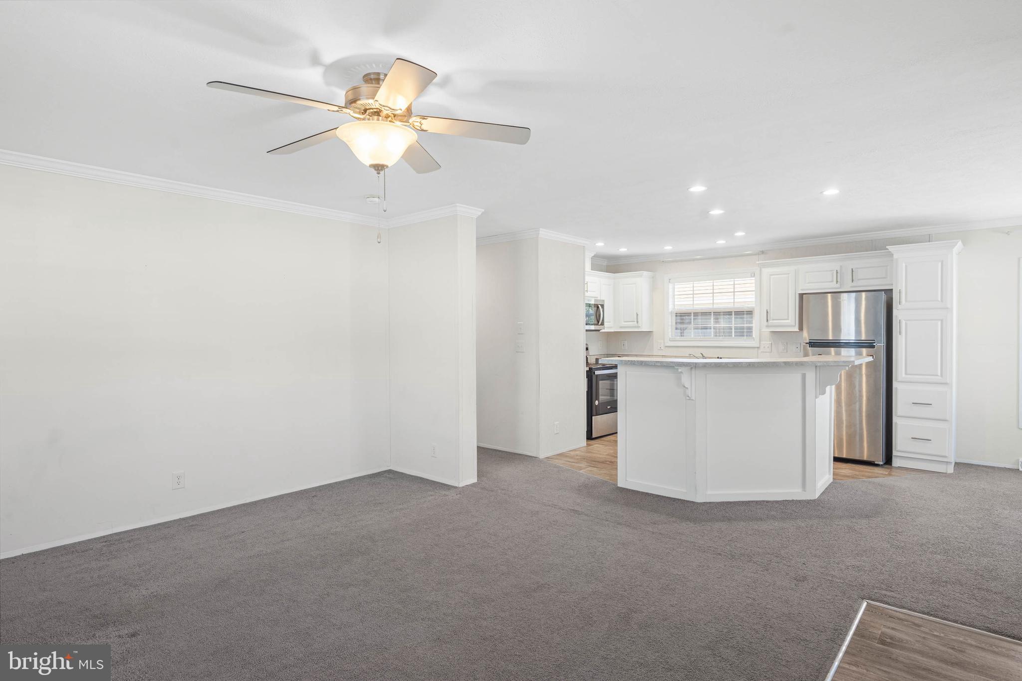 17247 Pine Water Drive Lewes, DE 19958 - Photo 9 of 32 a view of a kitchen with a sink and a chandelier fan