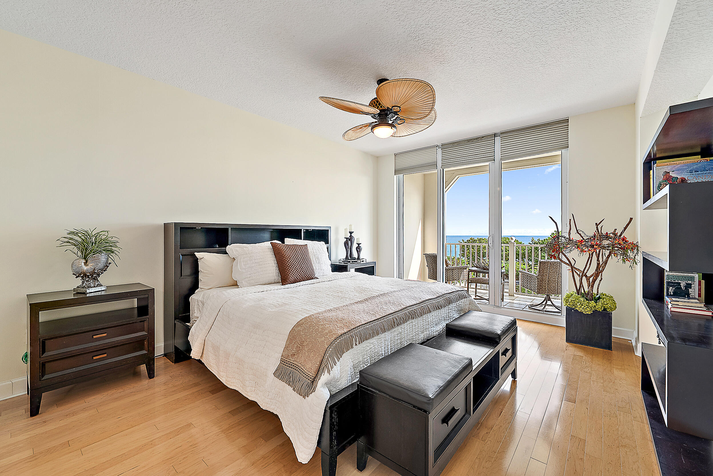 221 Ocean Grande Boulevard, Unit 407 Jupiter, FL 33477 - Photo 14 of 39 a bedroom with a bed a couch and a potted plant