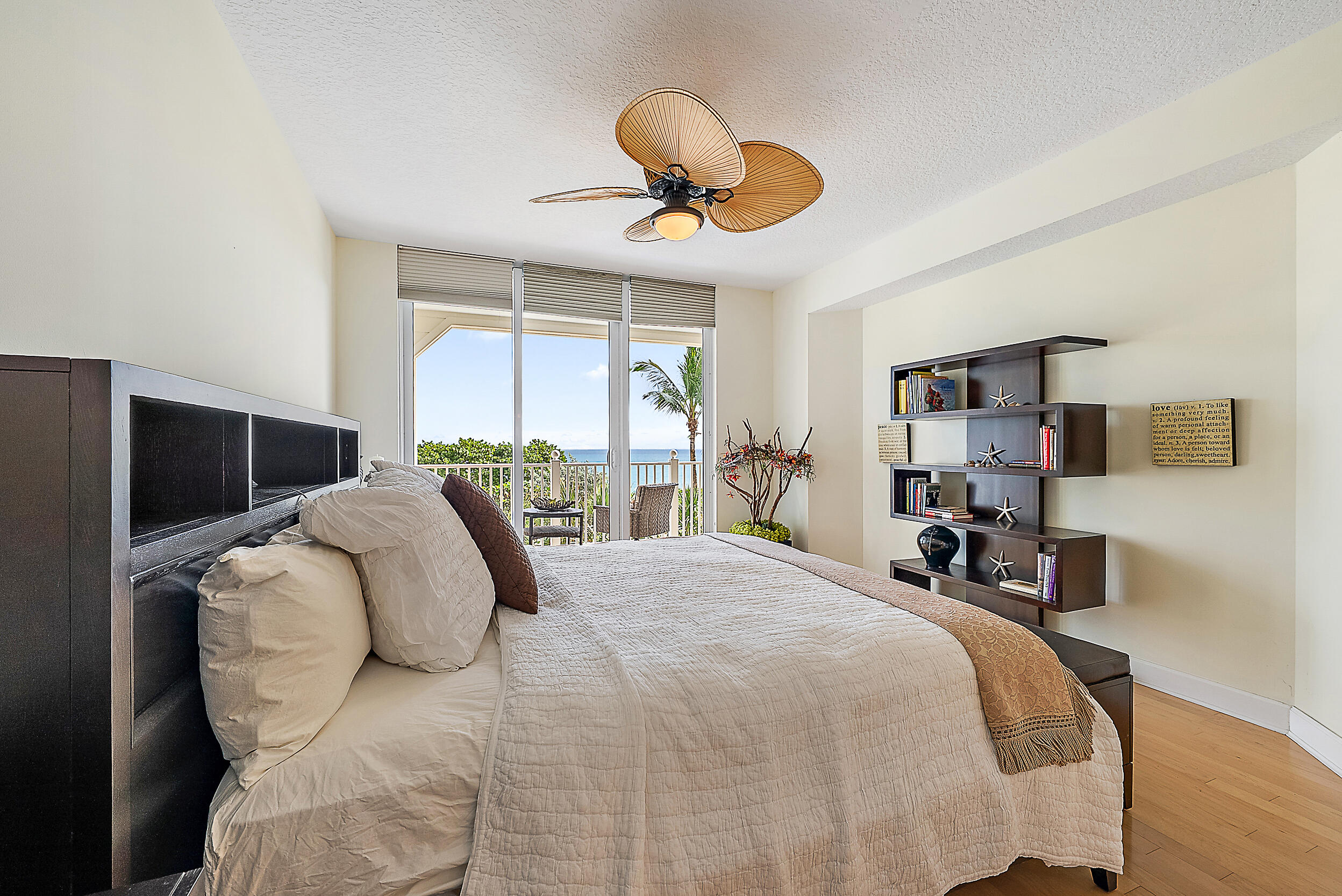221 Ocean Grande Boulevard, Unit 407 Jupiter, FL 33477 - Photo 15 of 39 a bedroom with a bed and a chandelier