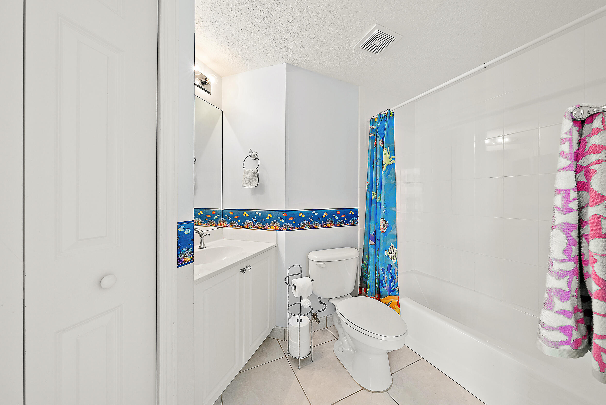 221 Ocean Grande Boulevard, Unit 407 Jupiter, FL 33477 - Photo 22 of 39 a bathroom with a sink a toilet and shower