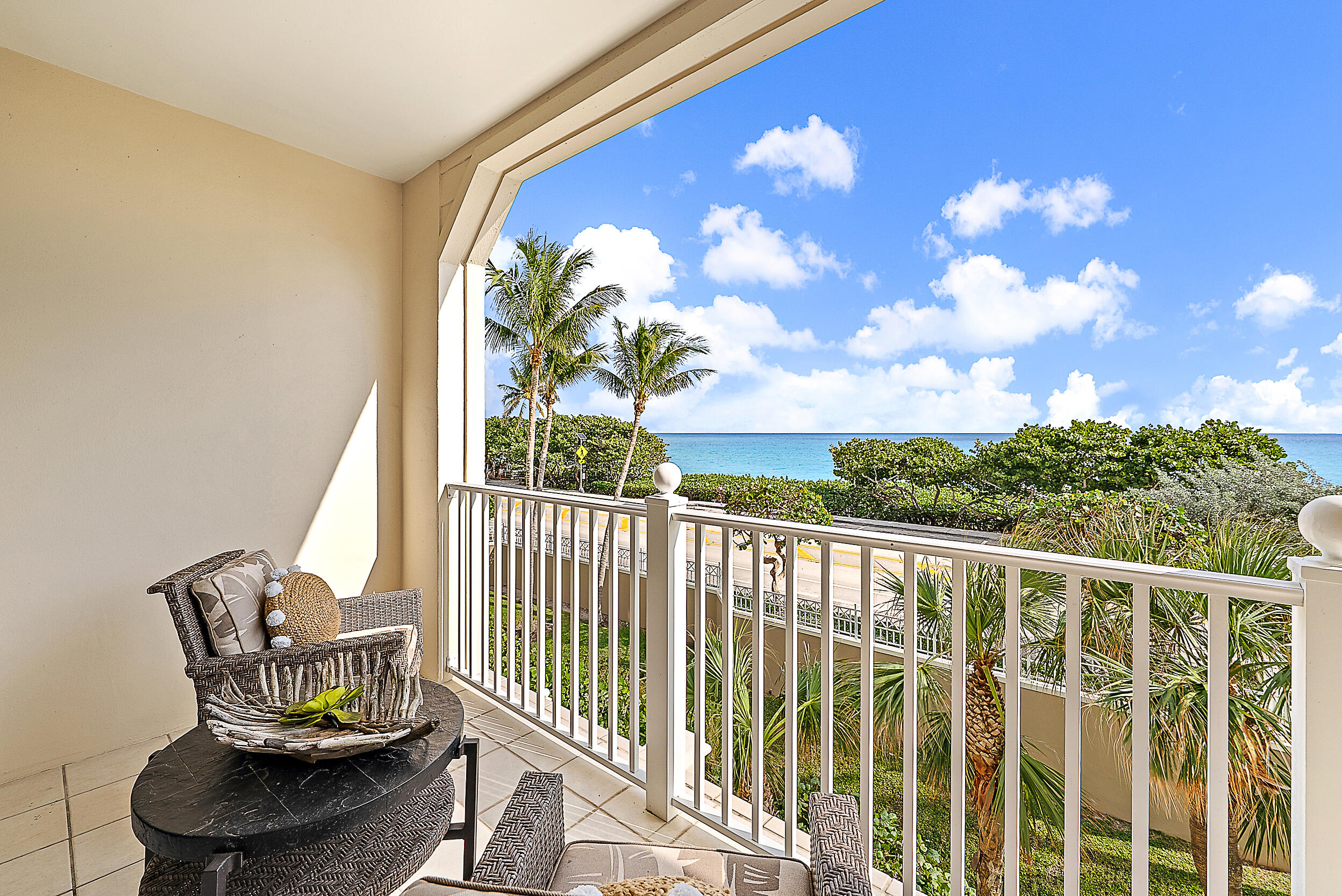 221 Ocean Grande Boulevard, Unit 407 Jupiter, FL 33477 - Photo 24 of 39 a view of a balcony with chair and table
