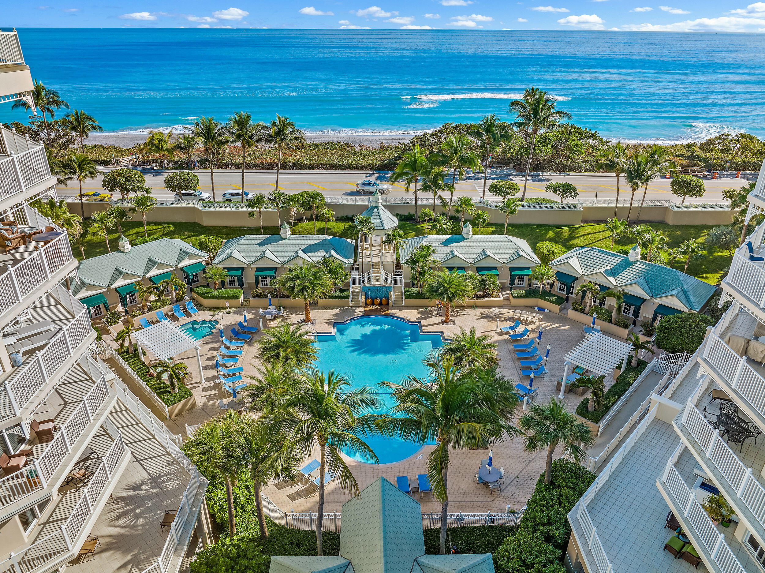 221 Ocean Grande Boulevard, Unit 407 Jupiter, FL 33477 - Photo 28 of 39 a view of a swimming pool with outdoor seating