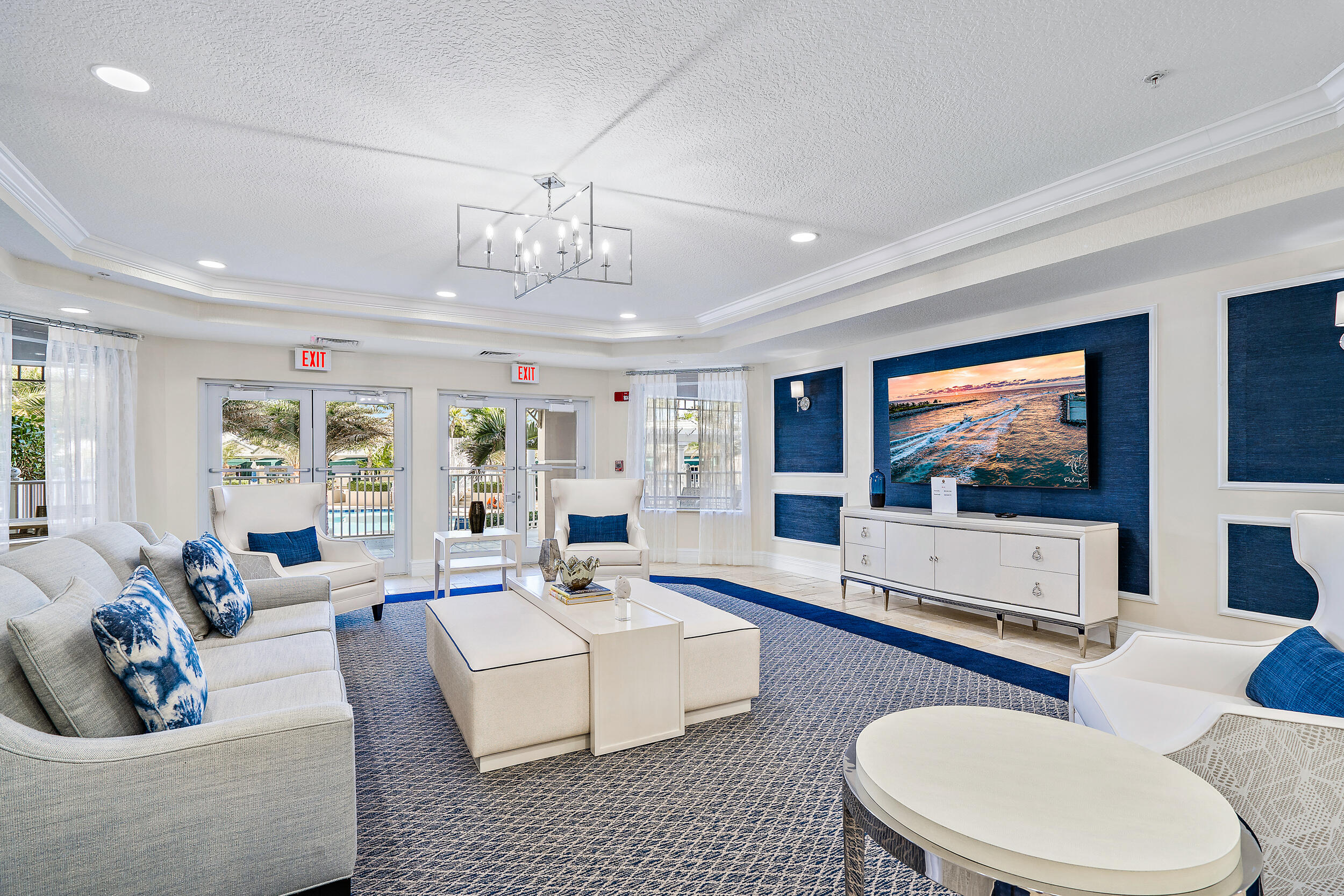 221 Ocean Grande Boulevard, Unit 407 Jupiter, FL 33477 - Photo 32 of 39 a living room with fireplace furniture and a flat screen tv