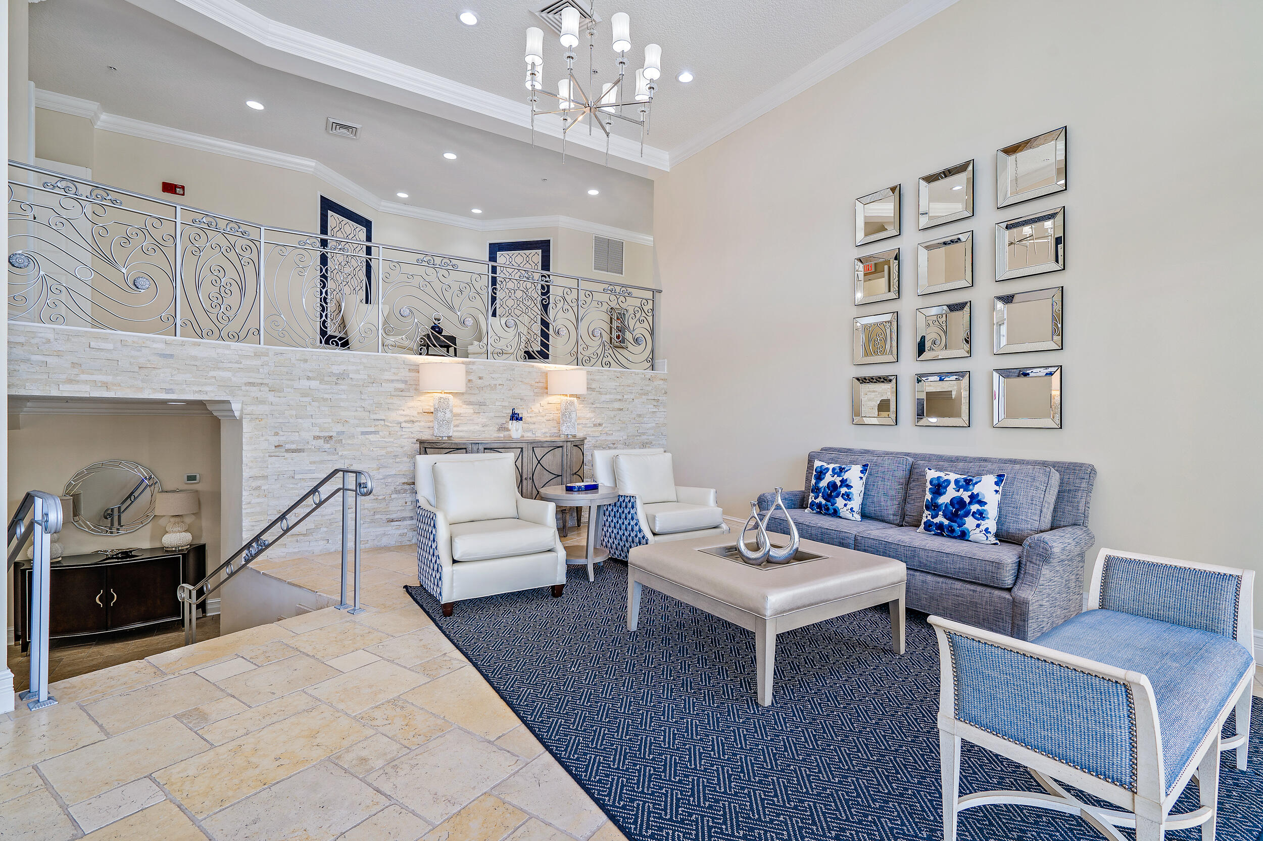 221 Ocean Grande Boulevard, Unit 407 Jupiter, FL 33477 - Photo 37 of 39 a living room with furniture and a chandelier