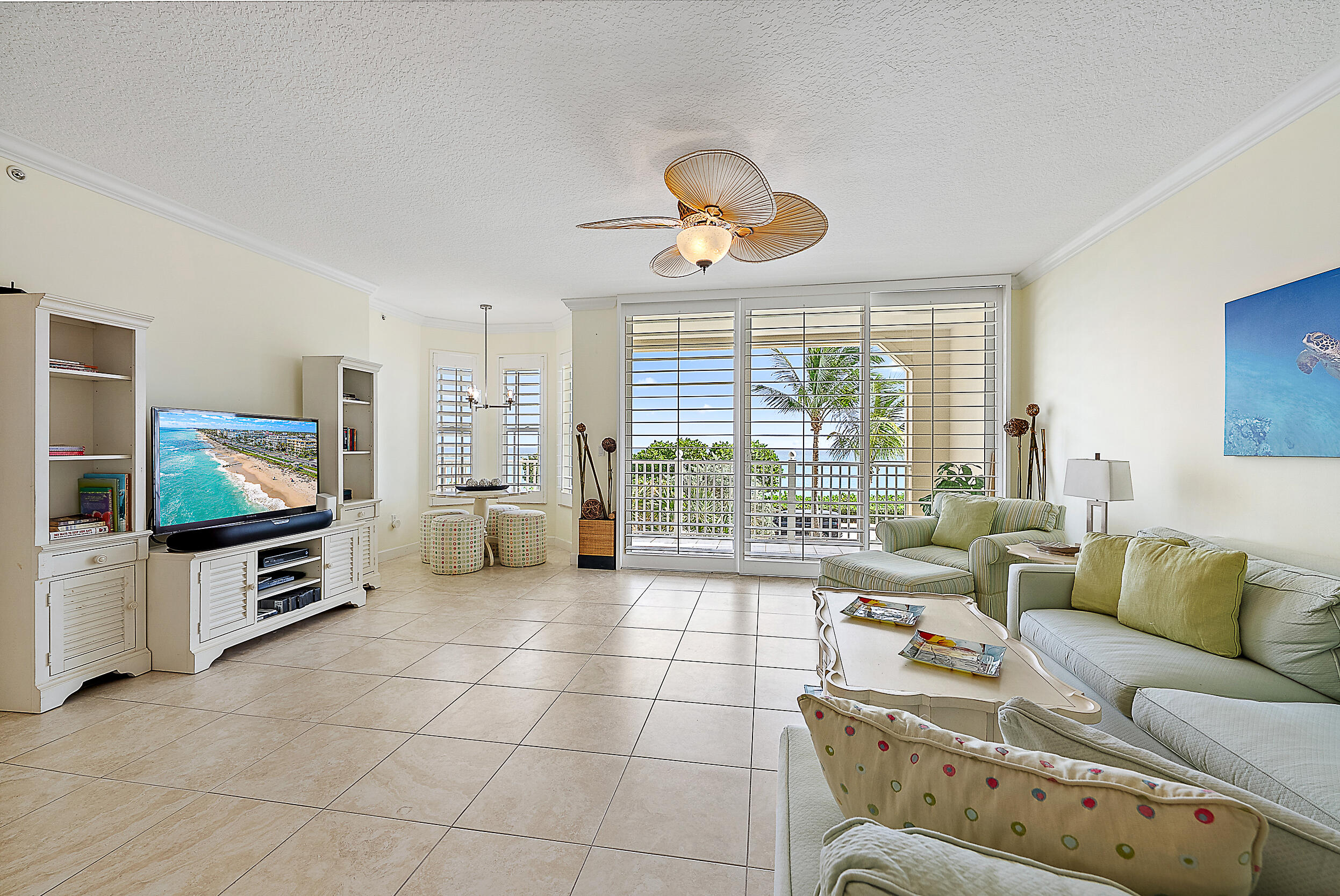 221 Ocean Grande Boulevard, Unit 407 Jupiter, FL 33477 - Photo 5 of 39 a living room with furniture and a flat screen tv