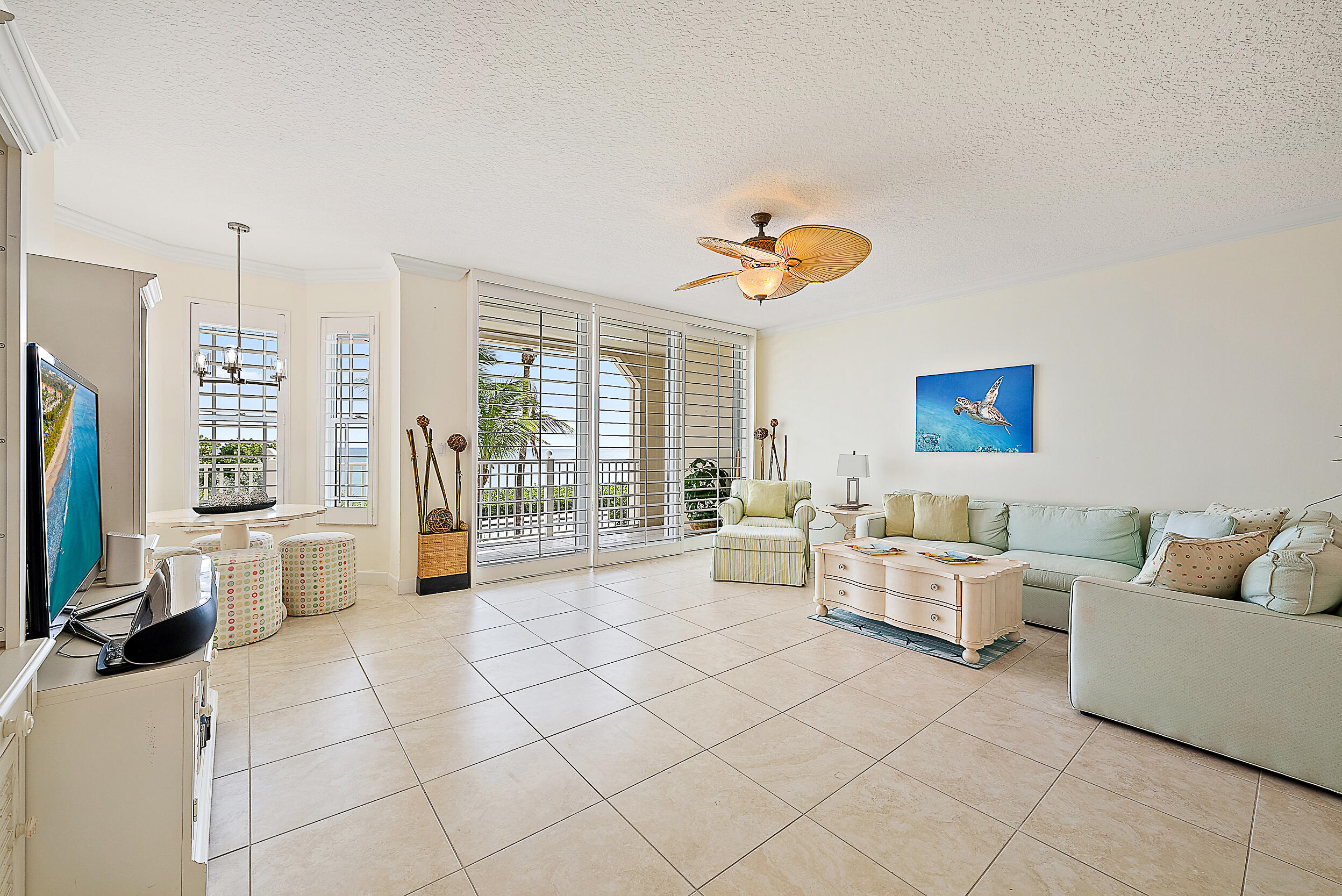 221 Ocean Grande Boulevard, Unit 407 Jupiter, FL 33477 - Photo 6 of 39 a living room with furniture and a flat screen tv