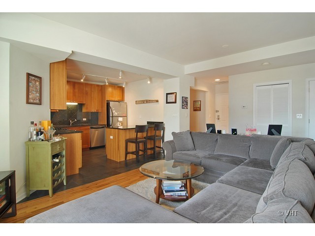 657 West Fulton Street, Unit 501 Chicago, IL 60661 - Photo 5 of 11 a living room with furniture and a large window