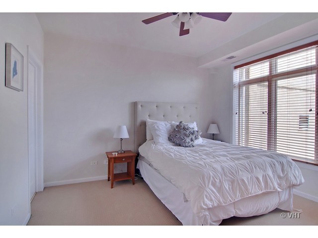 657 West Fulton Street, Unit 501 Chicago, IL 60661 - Photo 8 of 11 a bedroom with a bed and a window