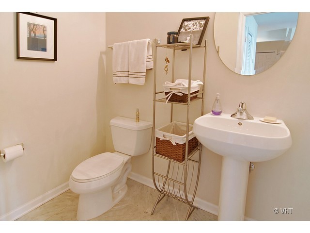 657 West Fulton Street, Unit 501 Chicago, IL 60661 - Photo 10 of 11 a bathroom with a toilet sink and mirror