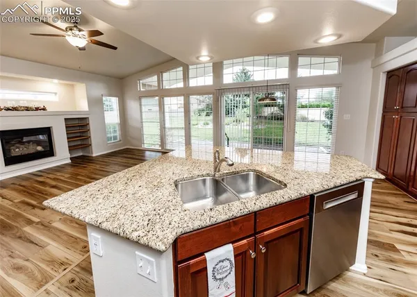 a kitchen with granite countertop a sink a counter top space and stainless steel appliances