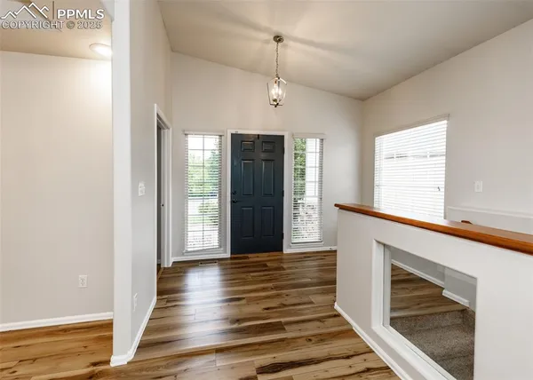 a view of a livingroom with wooden floor and a window
