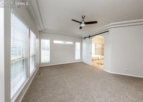 a view of a livingroom with an empty space and a window