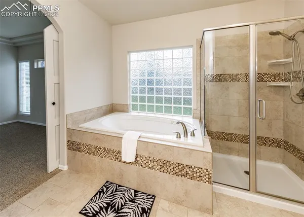 a bathroom with a tub and a shower