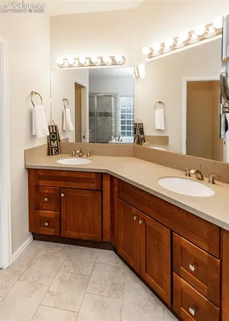 a spacious bathroom with a granite countertop sink and a mirror