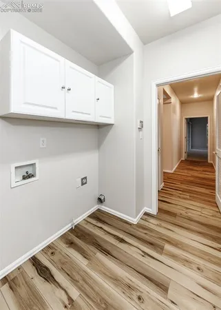 a view of a hallway with wooden floor and closet