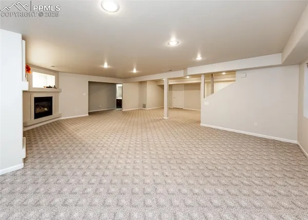 a view of empty room with a fireplace
