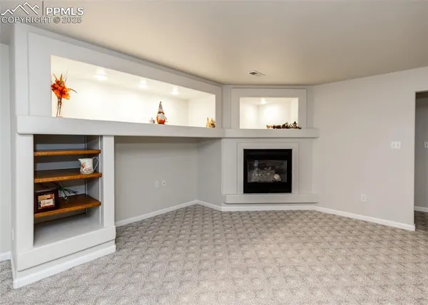 a living room with washer and a fireplace