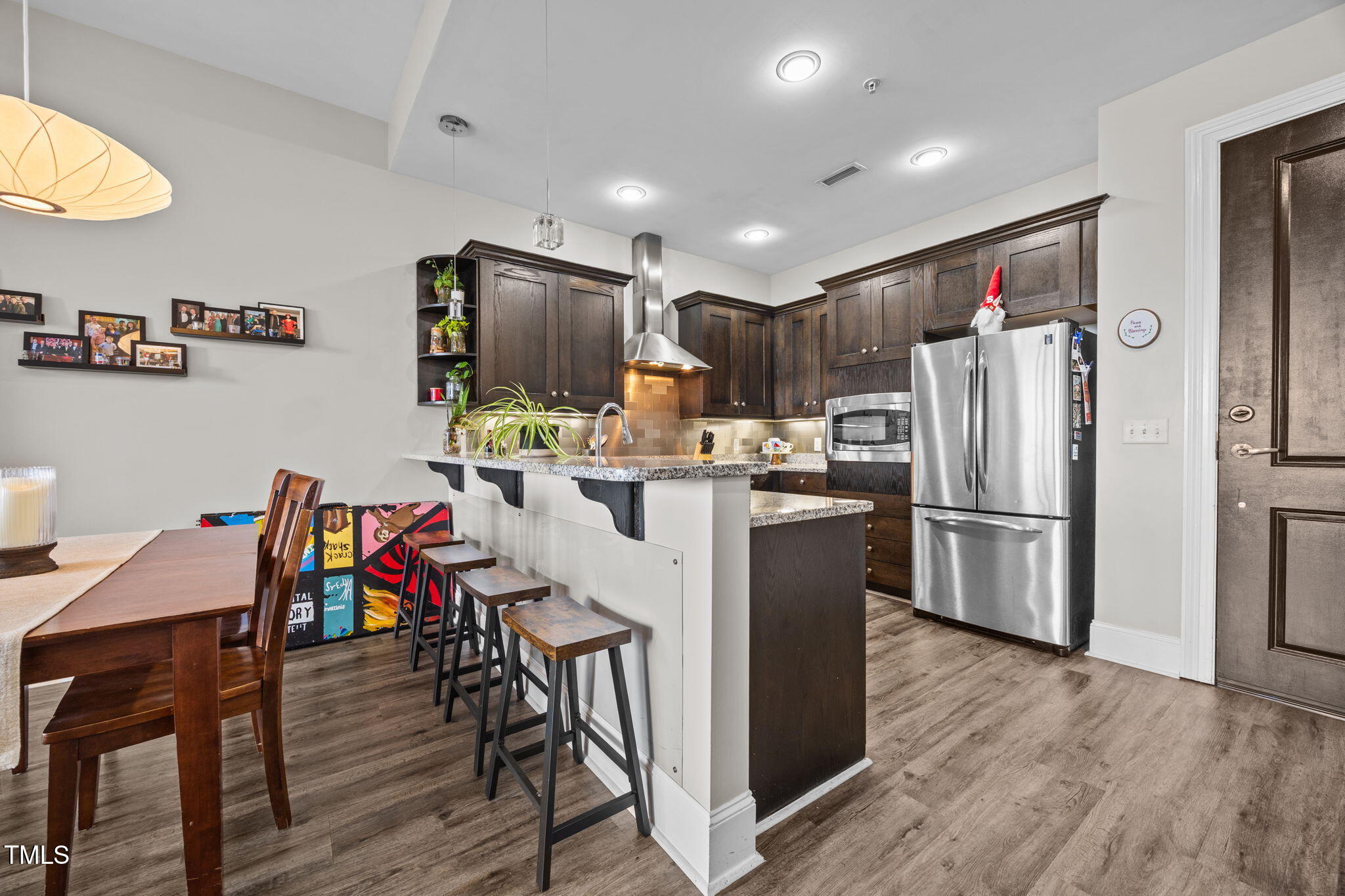400 West North Street, Unit 1028 Raleigh, NC 27603 - Photo 11 of 37 a kitchen with stainless steel appliances a refrigerator a stove a sink a dining table and chairs