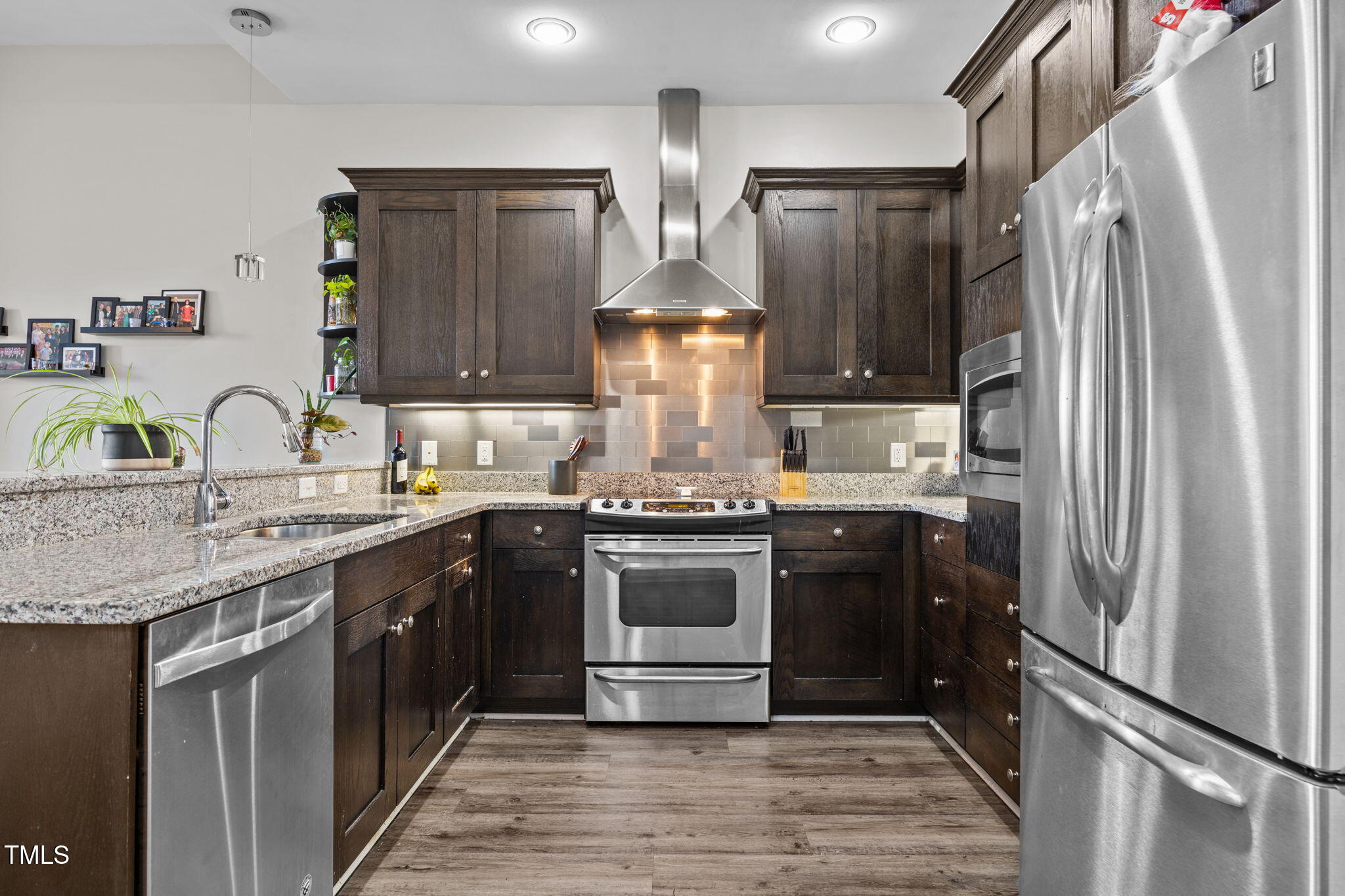 400 West North Street, Unit 1028 Raleigh, NC 27603 - Photo 12 of 37 a kitchen with stainless steel appliances granite countertop a refrigerator and a stove