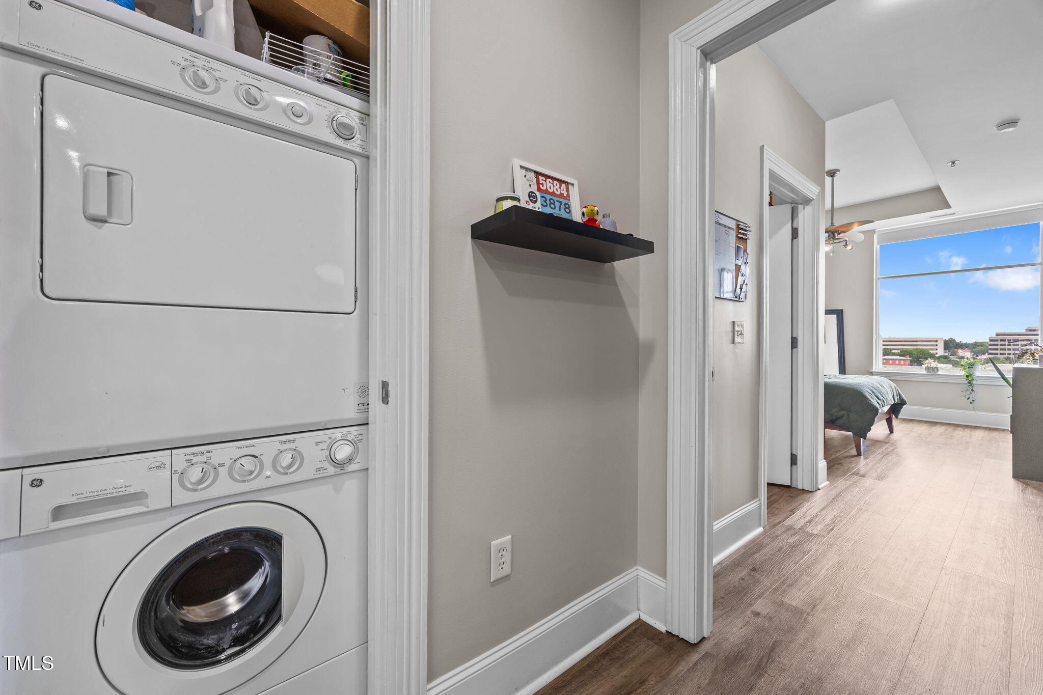 400 West North Street, Unit 1028 Raleigh, NC 27603 - Photo 17 of 37 a view of a hallway with washer and dryer wooden floor