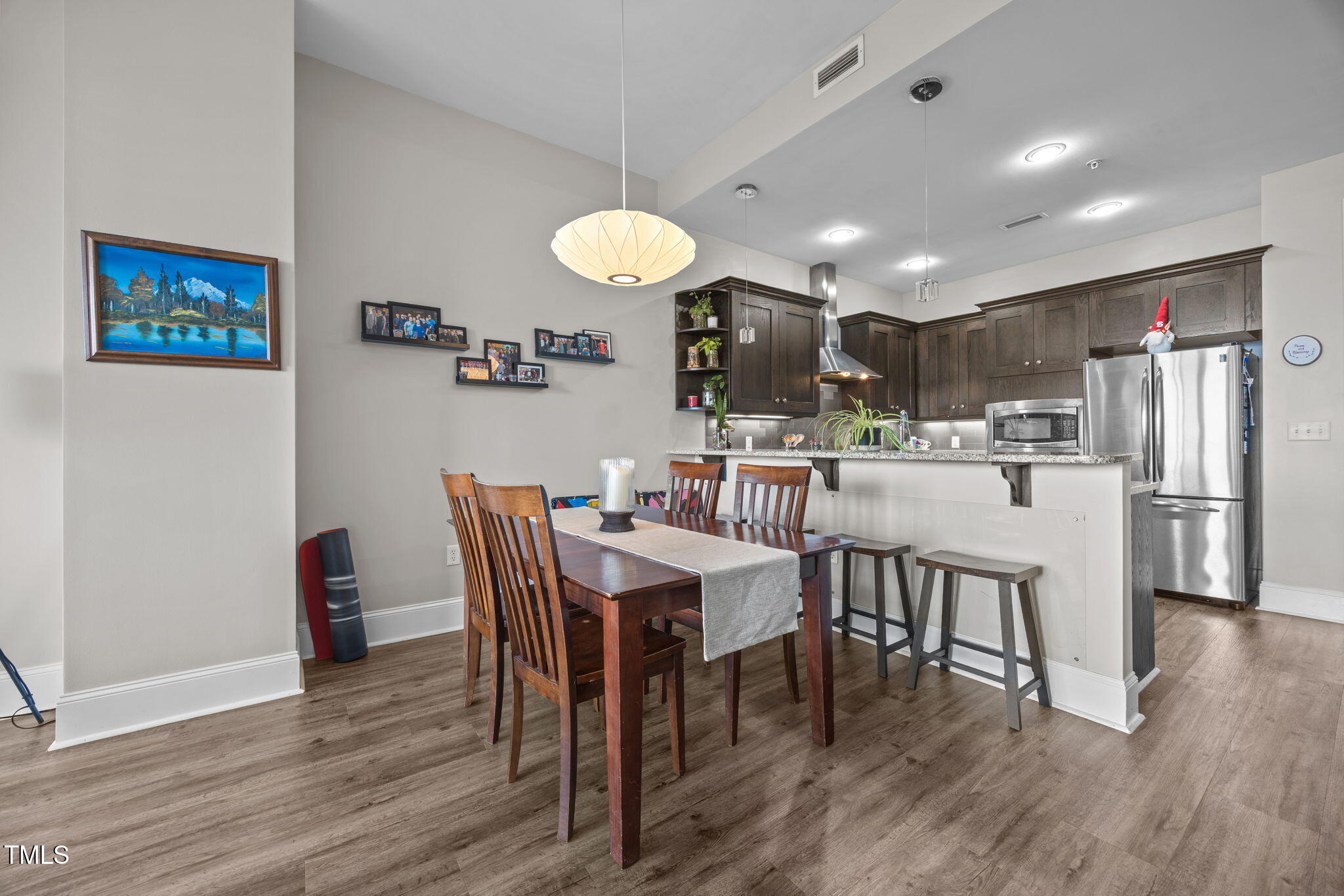 400 West North Street, Unit 1028 Raleigh, NC 27603 - Photo 4 of 37 a view of a dining room with furniture and wooden floor
