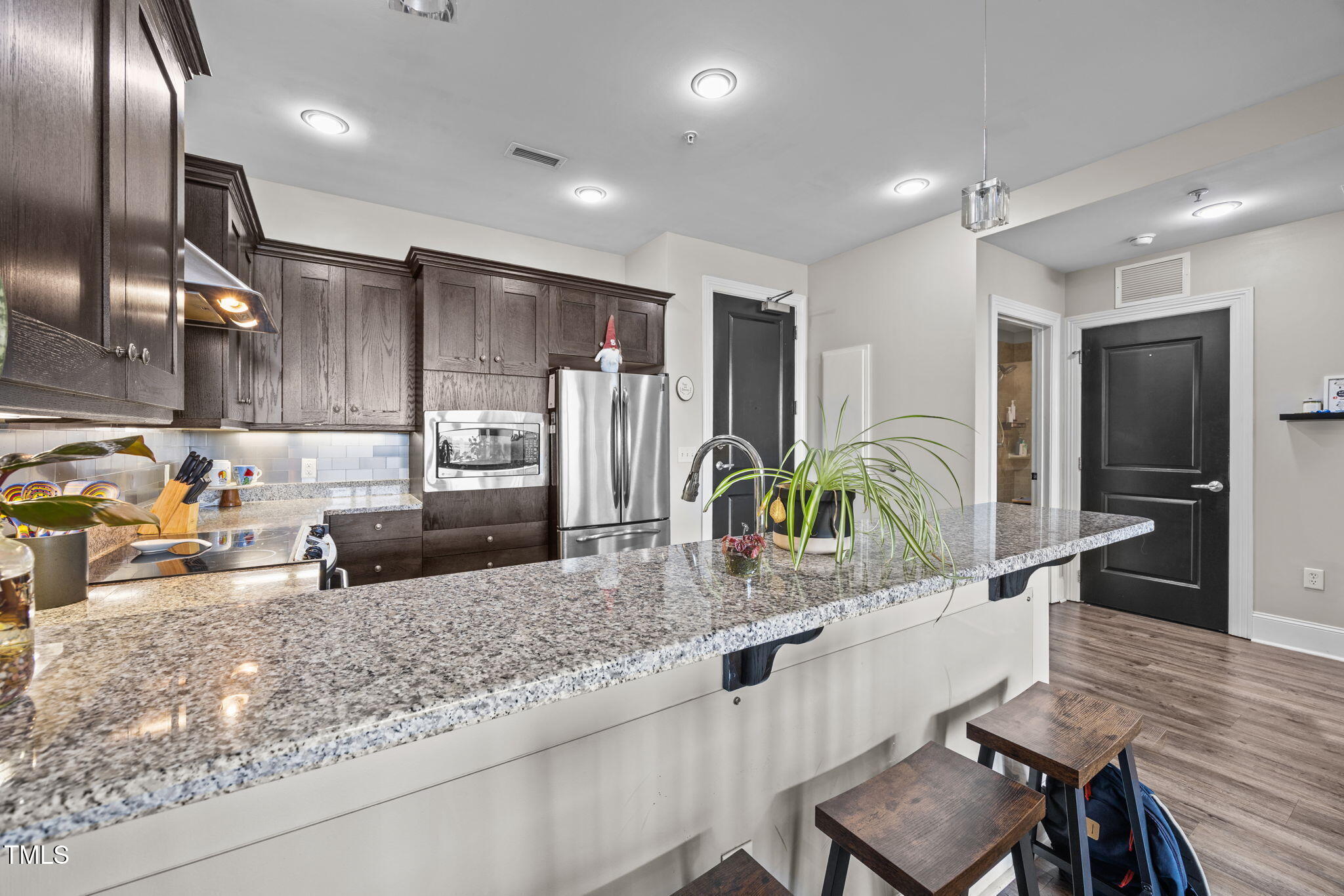 400 West North Street, Unit 1028 Raleigh, NC 27603 - Photo 5 of 37 a kitchen with sink refrigerator and microwave
