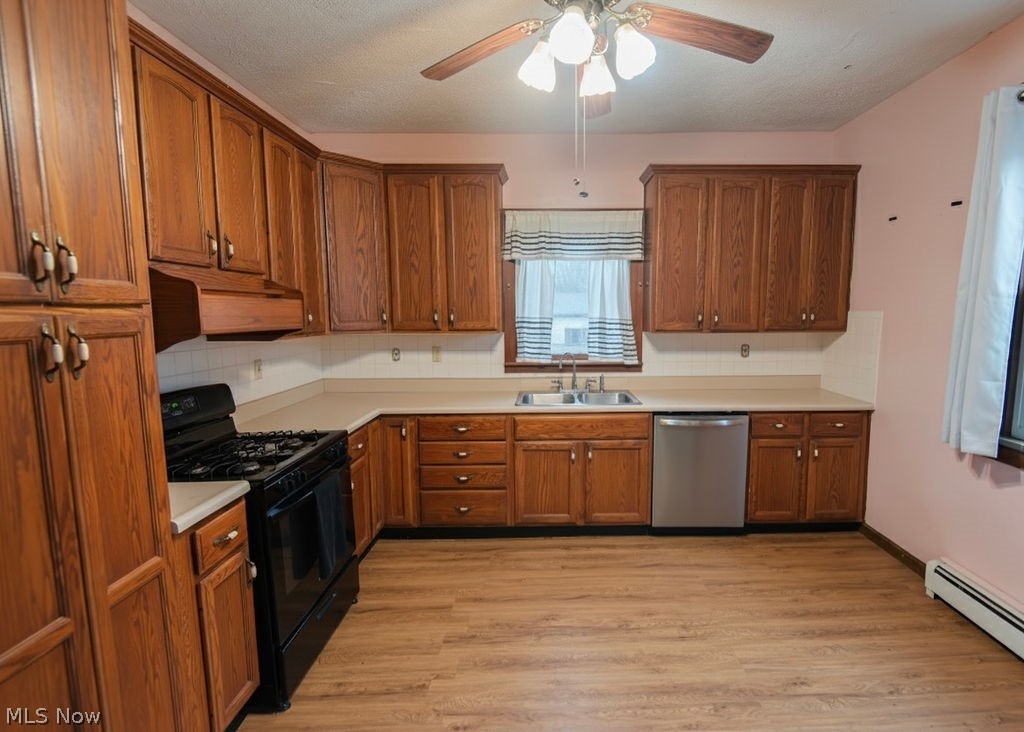 1195 South Johnson Road Sebring, OH 44672 - Photo 5 of 34 Kitchen featuring black range with gas cooktop, light countertops, ceiling fan, wood finish cabinetry, and stainless steel dishwasher