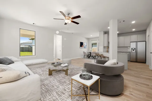 a living room with furniture and kitchen view