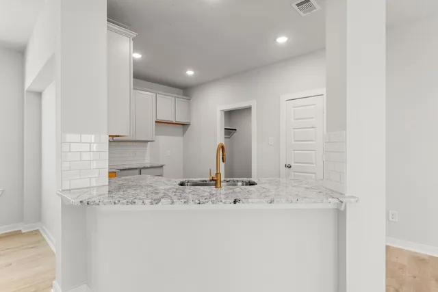 a kitchen with kitchen island granite countertop counter top space and cabinets