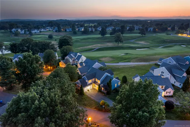 an aerial view of a house with garden space and outdoor seating
