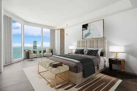 a bedroom with a bed a mirror and a large window