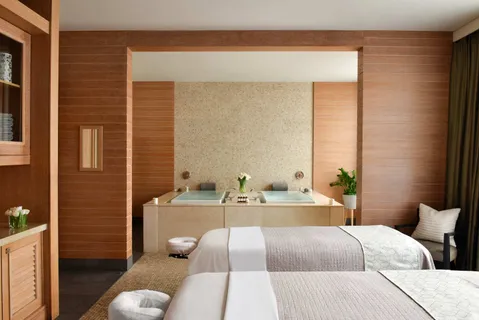 a bedroom with a bed and a night stand