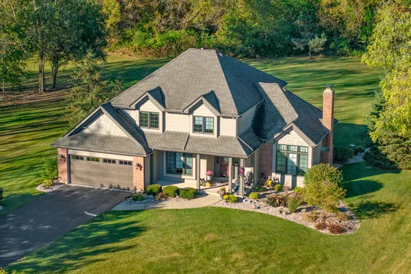 a aerial view of a house with swimming pool and porch