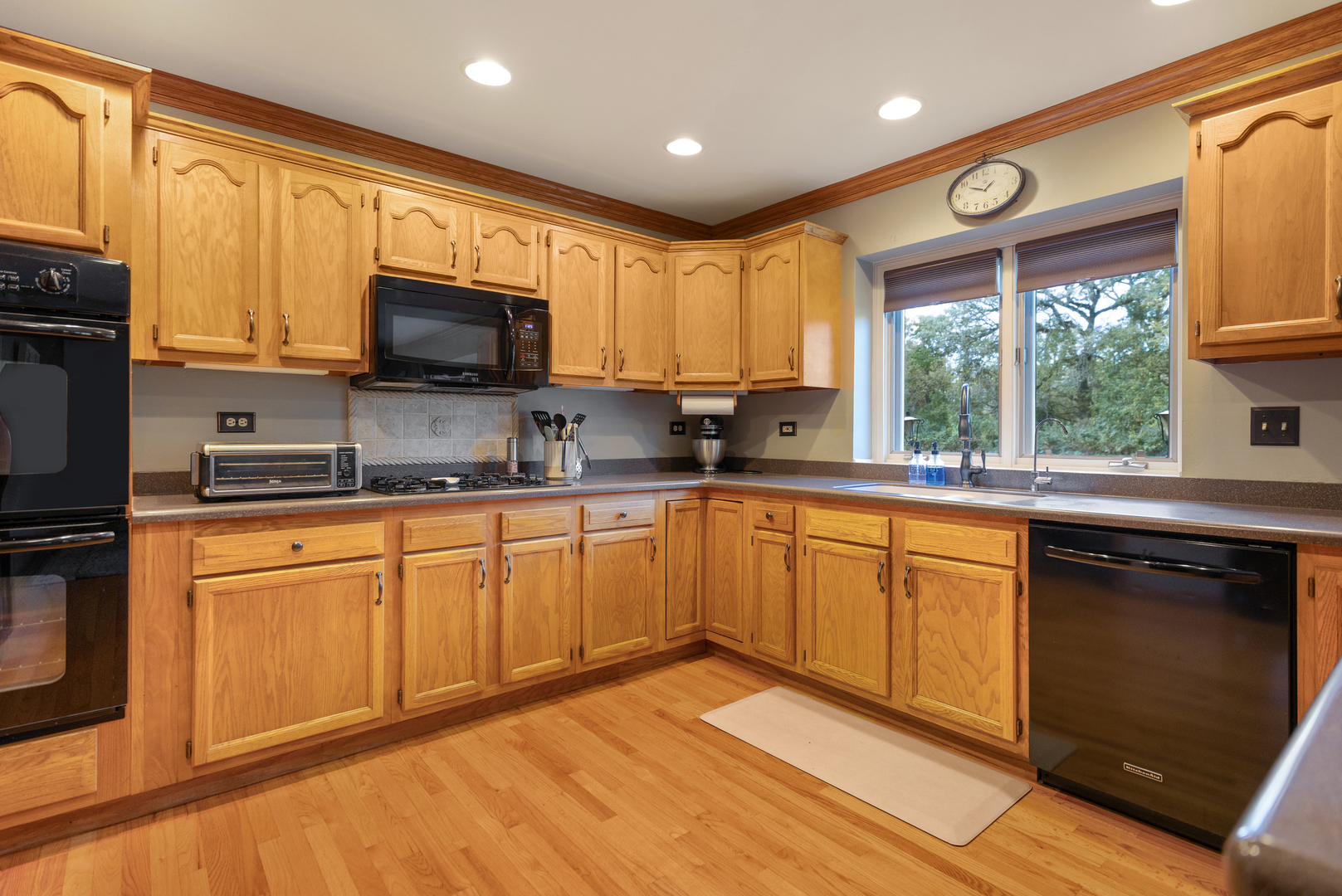 10317 Ridge Lane Huntley, IL 60142 - Photo 11 of 42 a kitchen with stainless steel appliances granite countertop a stove sink microwave and refrigerator