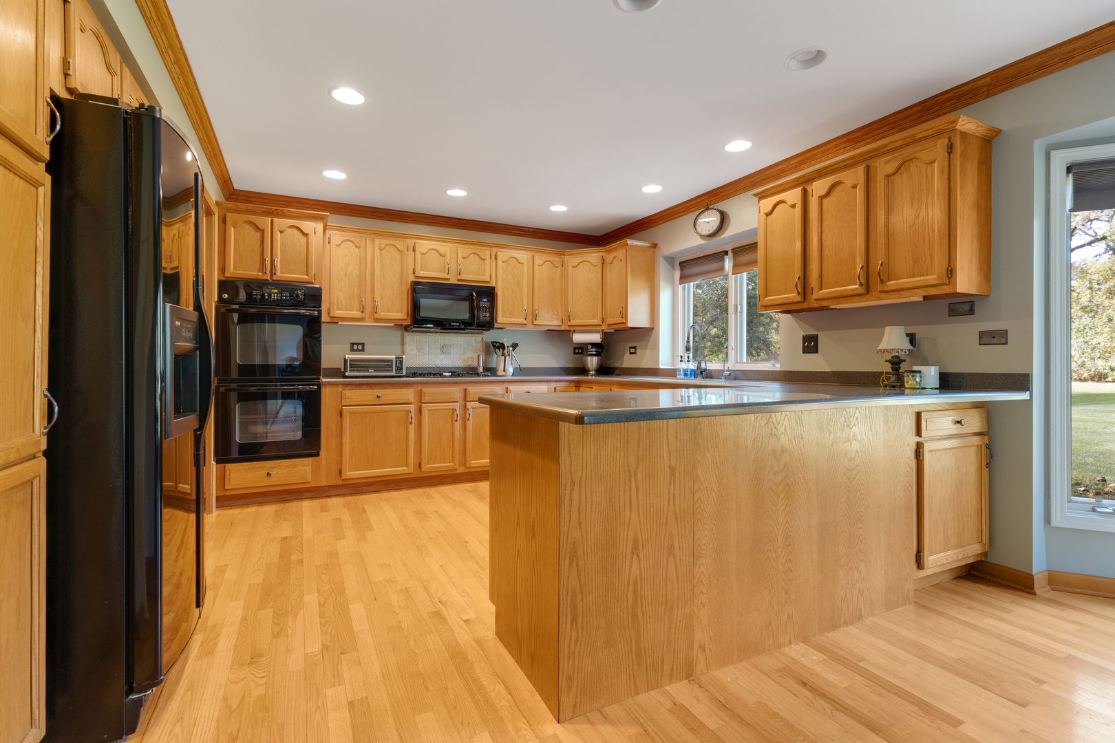 10317 Ridge Lane Huntley, IL 60142 - Photo 13 of 42 a kitchen with stainless steel appliances granite countertop a refrigerator a stove top oven a sink and cabinets