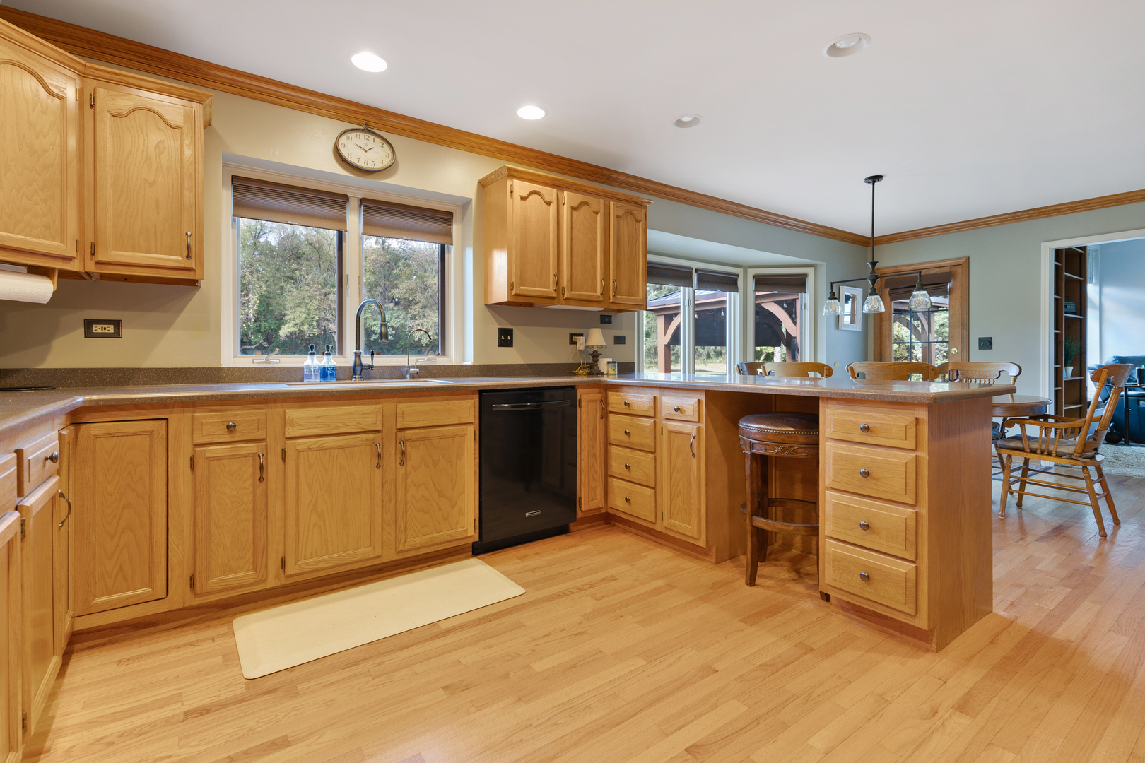 10317 Ridge Lane Huntley, IL 60142 - Photo 14 of 42 a kitchen with stainless steel appliances granite countertop a sink cabinets and wooden floor