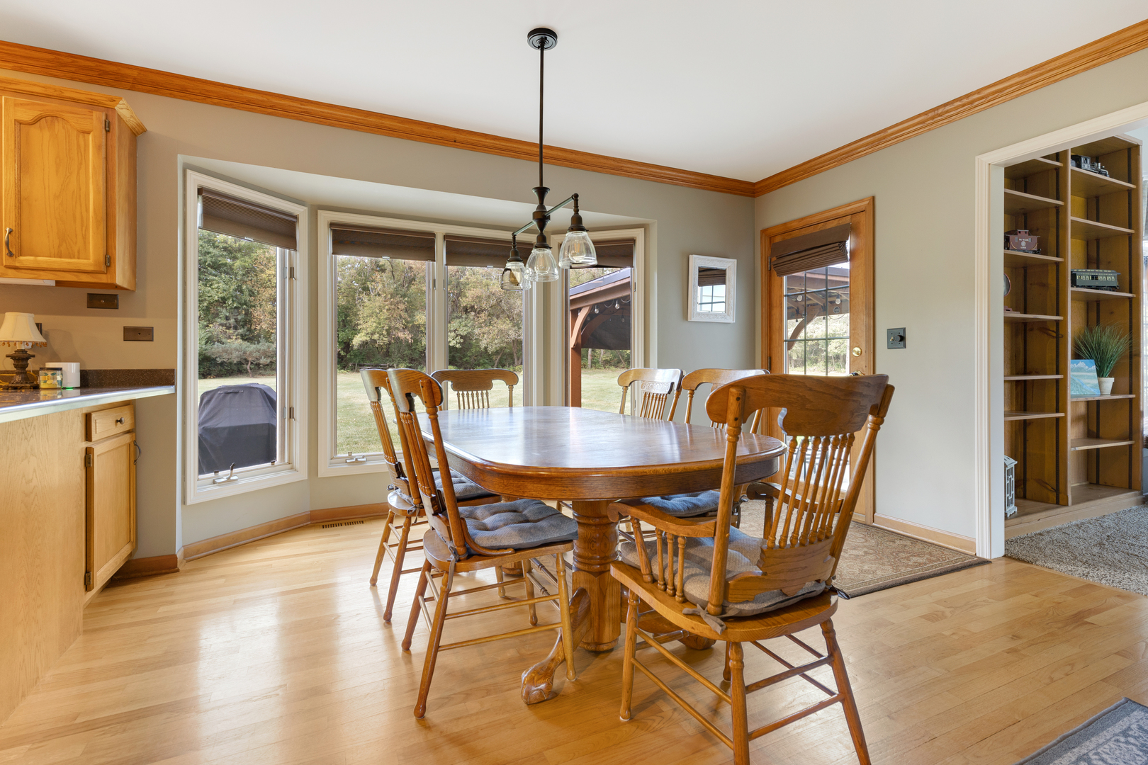 10317 Ridge Lane Huntley, IL 60142 - Photo 17 of 42 a view of a dining room with furniture window and wooden floor