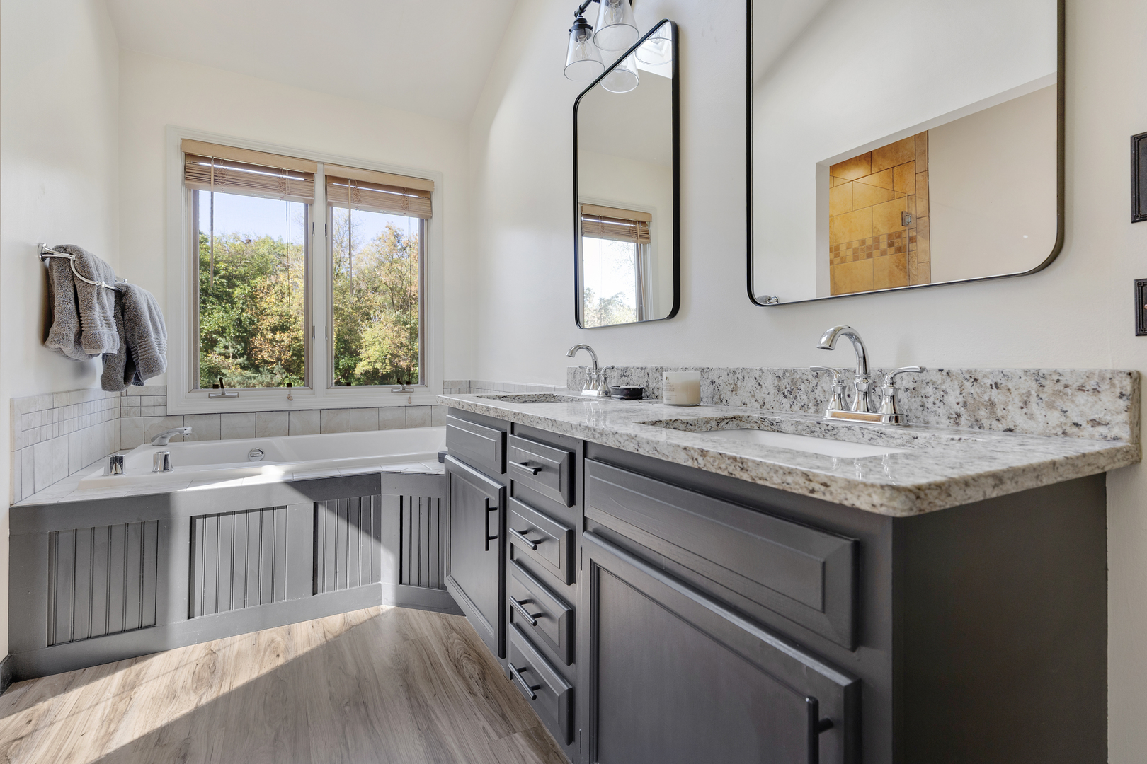 10317 Ridge Lane Huntley, IL 60142 - Photo 25 of 42 a bathroom with a granite countertop sink a large mirror and a window