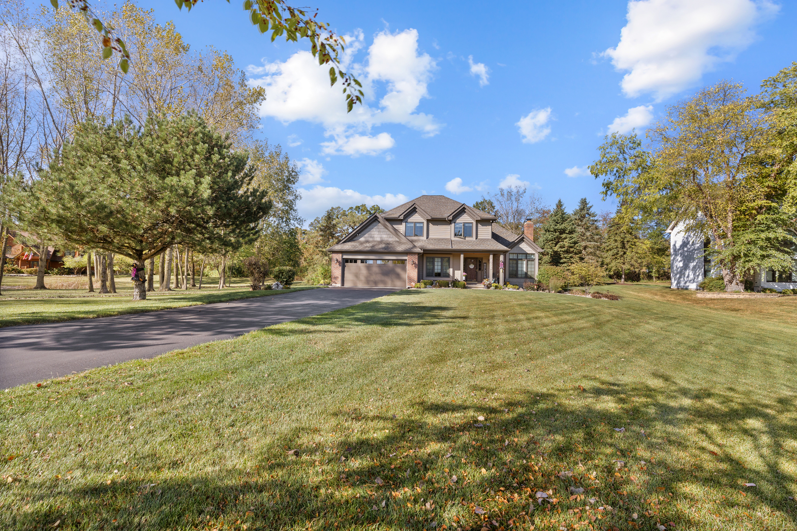 10317 Ridge Lane Huntley, IL 60142 - Photo 9 of 42 a front view of a house with a yard