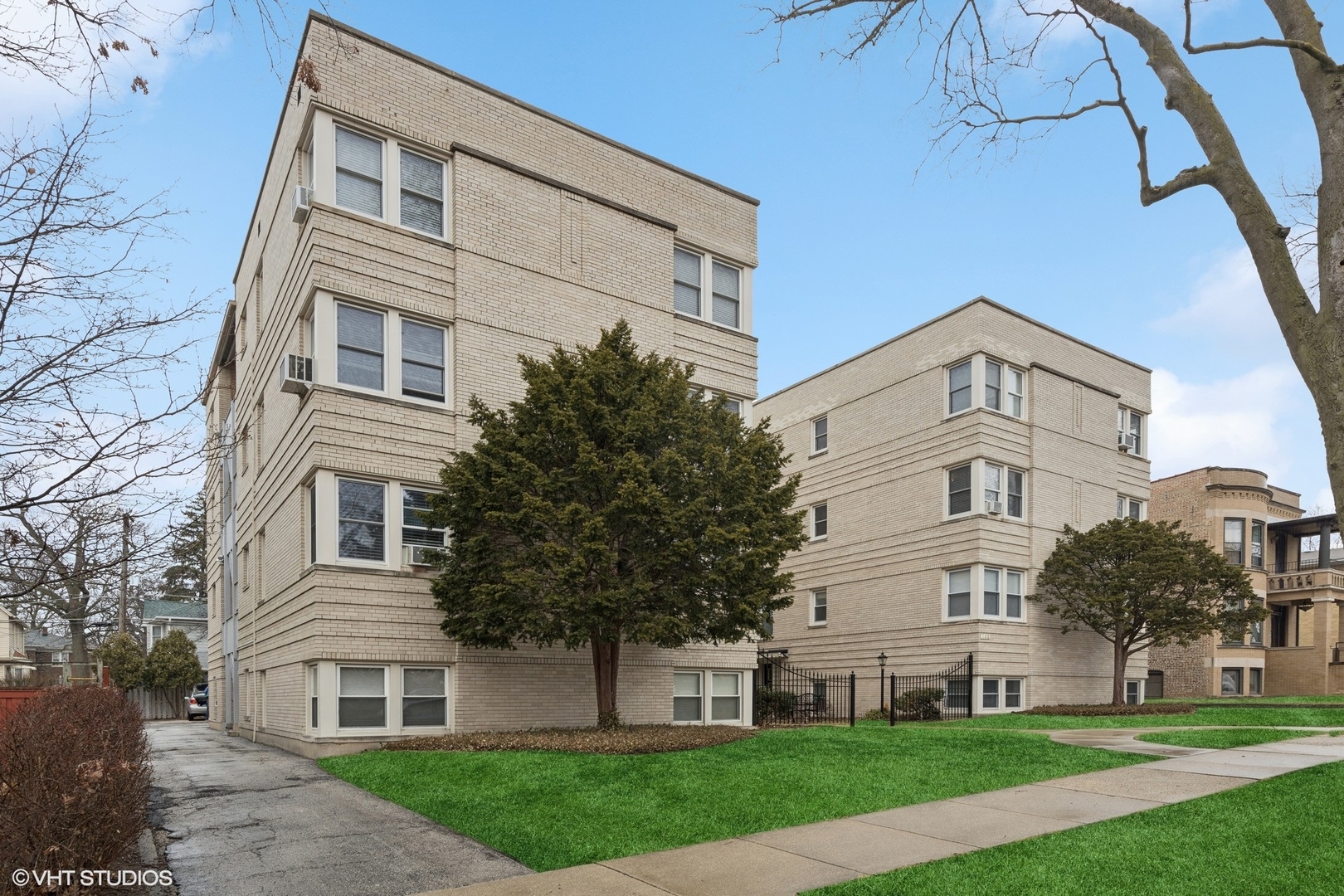 100 Pine Avenue, Unit 3 Riverside, IL 60546 - Photo 2 of 14 a view of a white building among the yard