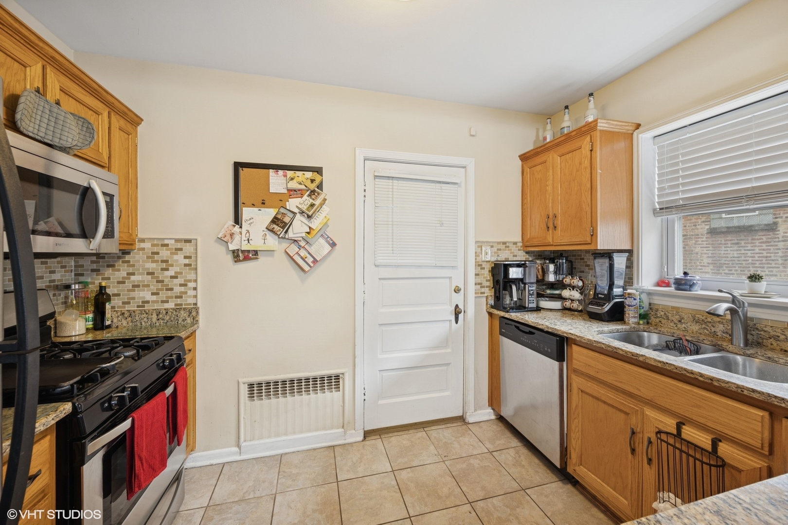 100 Pine Avenue, Unit 3 Riverside, IL 60546 - Photo 5 of 14 a kitchen with stainless steel appliances granite countertop a stove a sink and a microwave
