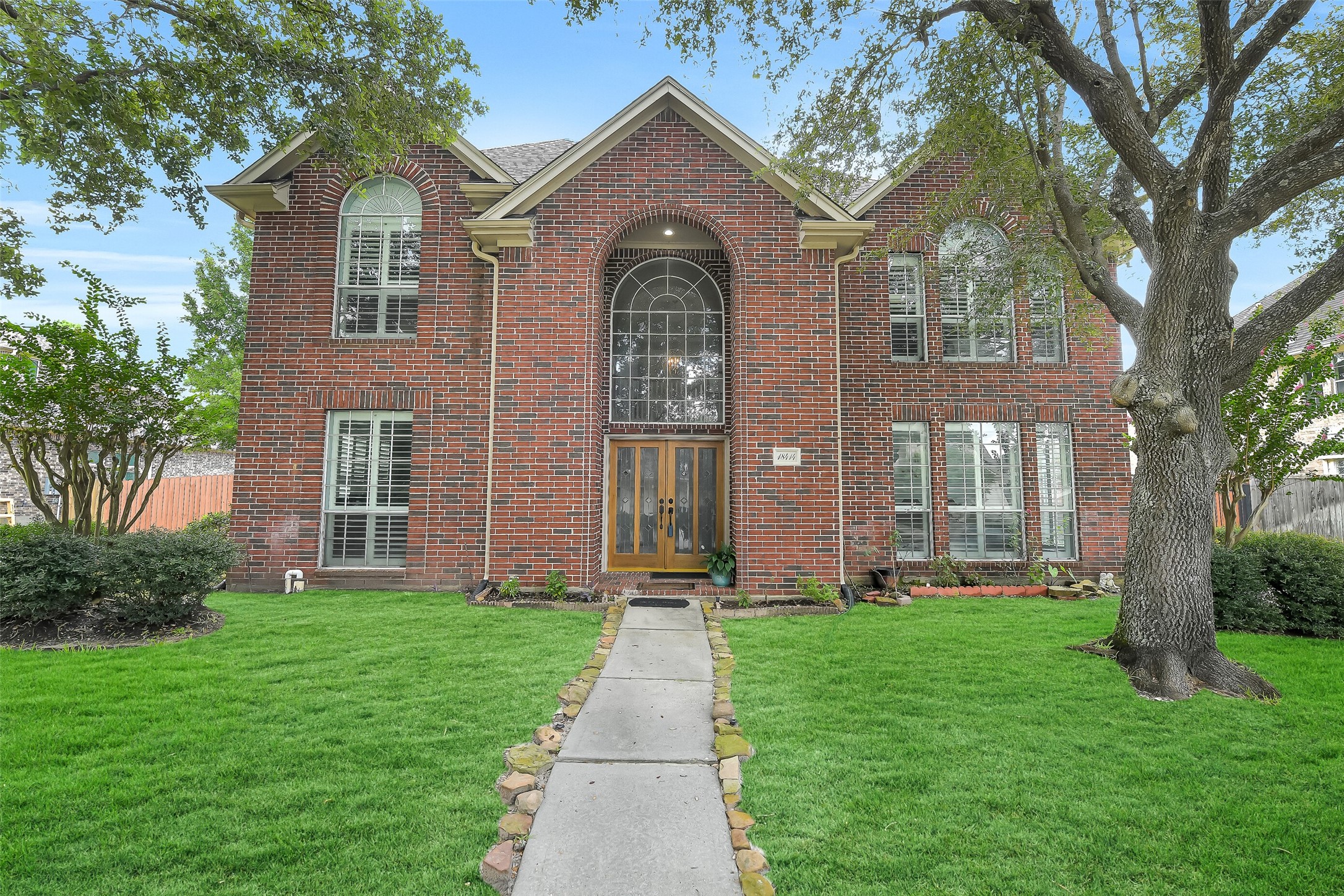 a front view of a house with garden