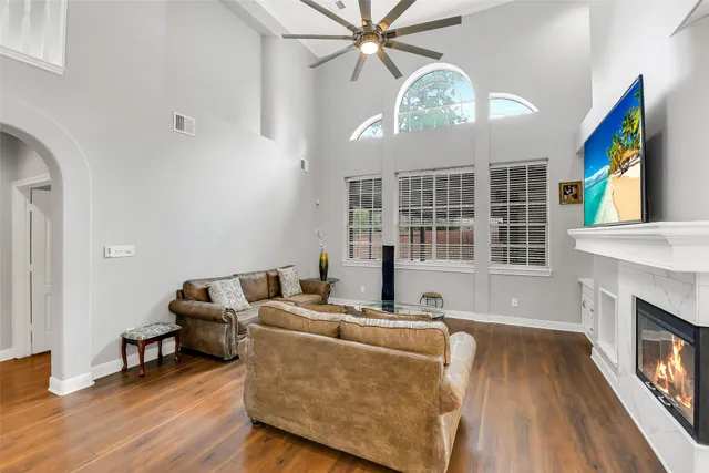 a living room with furniture a fireplace and a large window