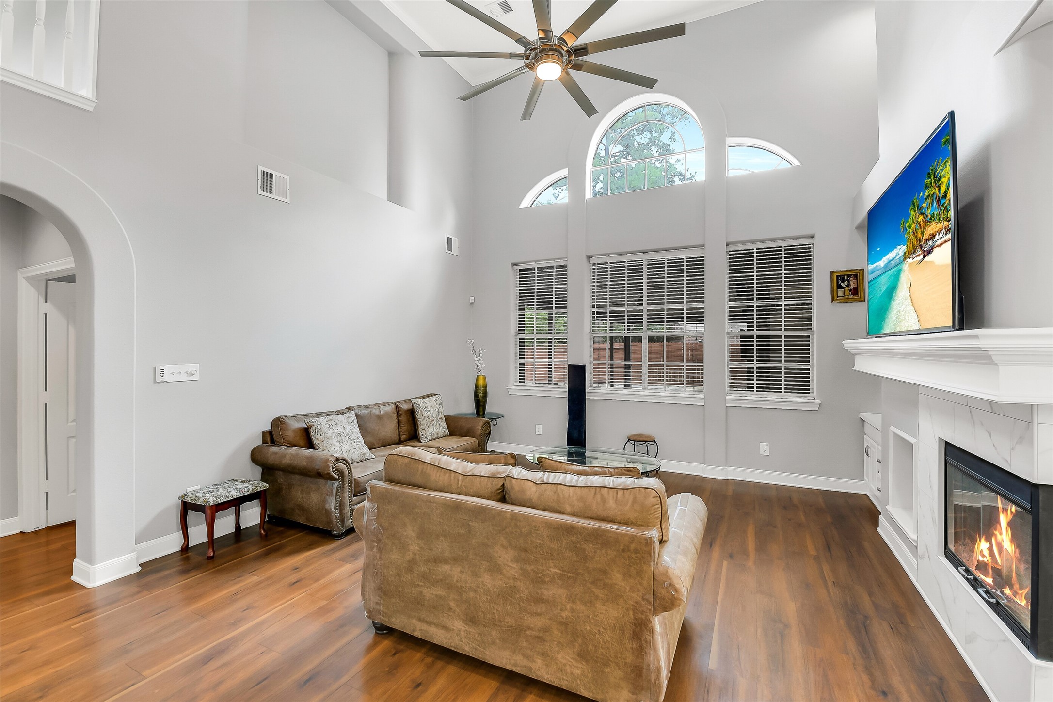 18414 Bull Pine Drive Spring, TX 77379 - Photo 11 of 43 a living room with furniture a fireplace and a large window