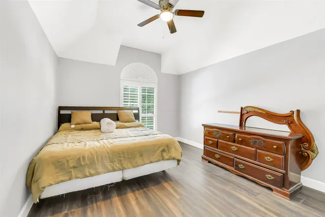 a bedroom with a bed and window