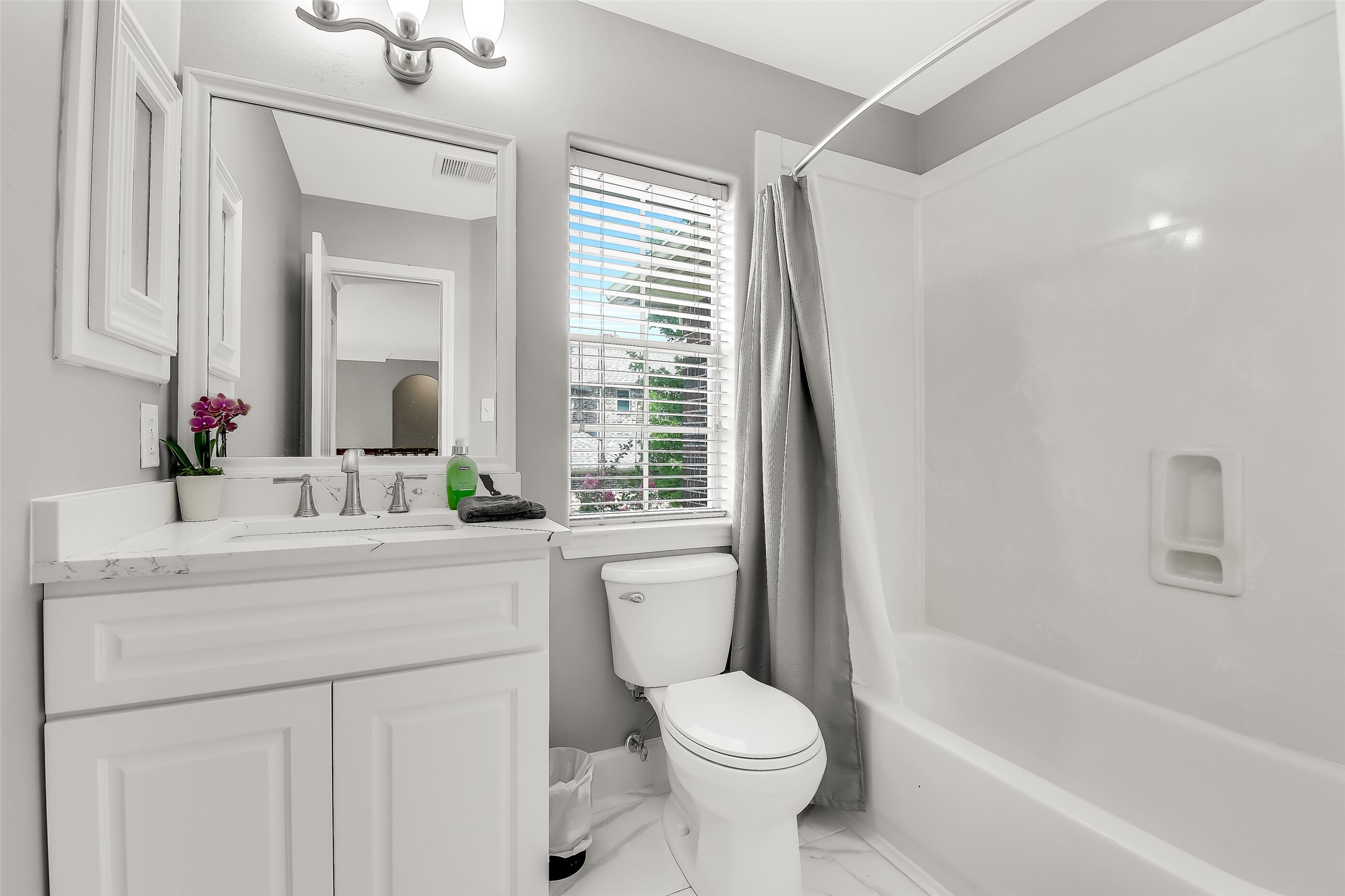 18414 Bull Pine Drive Spring, TX 77379 - Photo 25 of 43 a bathroom with a toilet a sink a mirror a bathtub and vanity