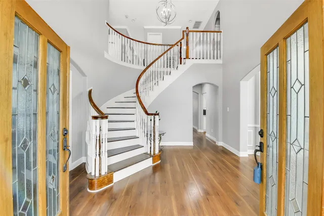 a view of entryway and hall with wooden floor