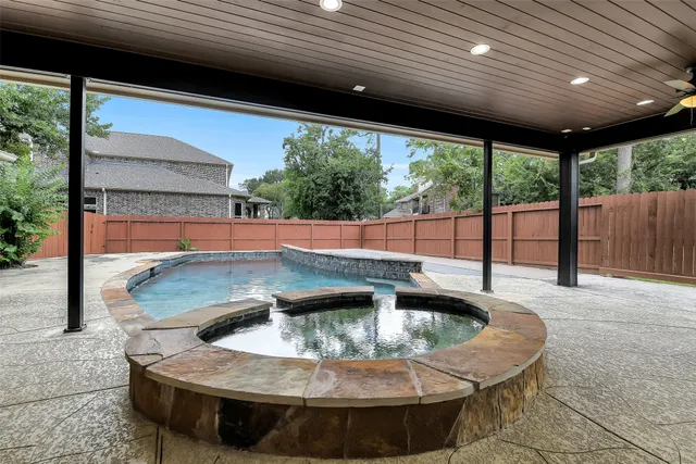 a view of swimming pool with a couches in patio