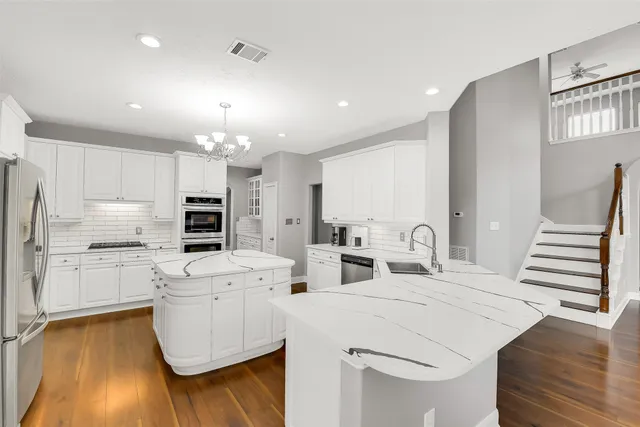 a kitchen with appliances a sink and cabinets