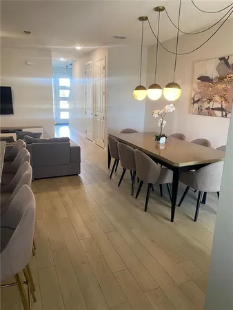 a view of a dining room with furniture and a chandelier